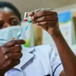 A health worker administers a routine childhood vaccine at a Nigerian primary health centre