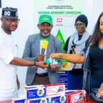 Edo deputy governor prepays NHIA cover for 4,000 constituents NHIA health insurance in Edo State beneficiary receiving an activated insurance card at a medical center