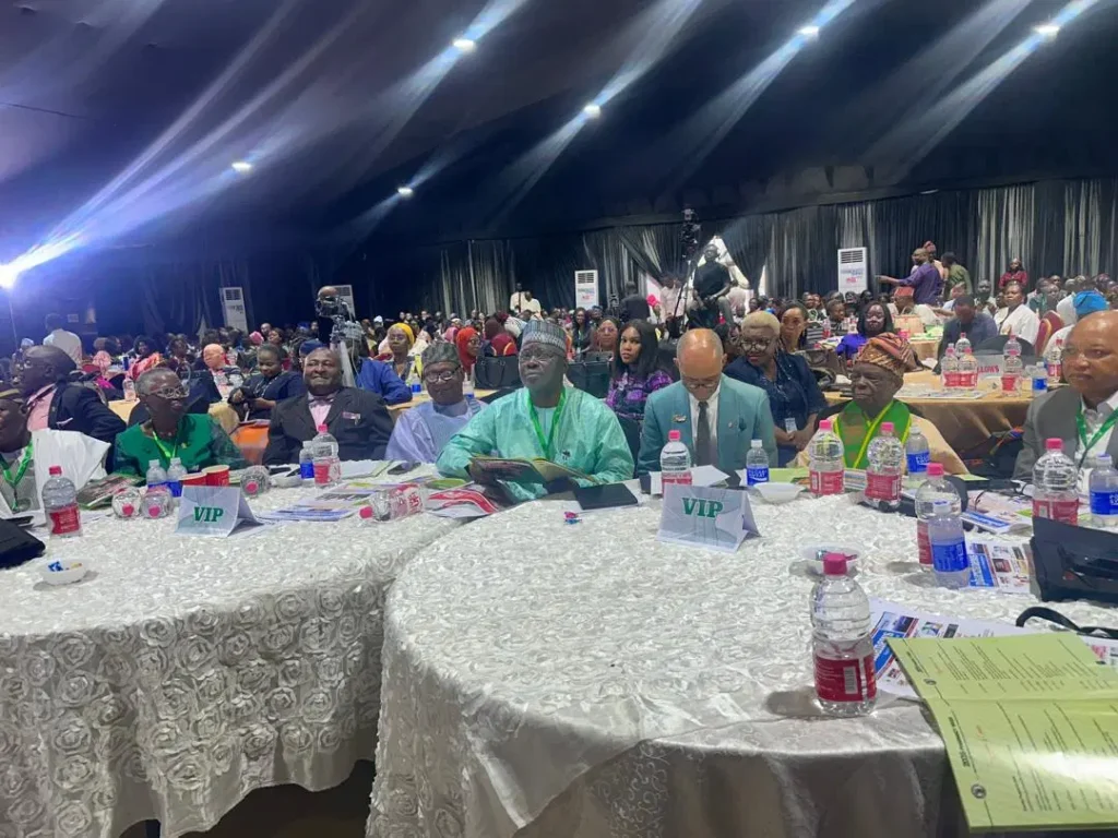Pharmacists at Pharmacy Week in Lagos discussing Pharmacy Council of Nigeria regulation.