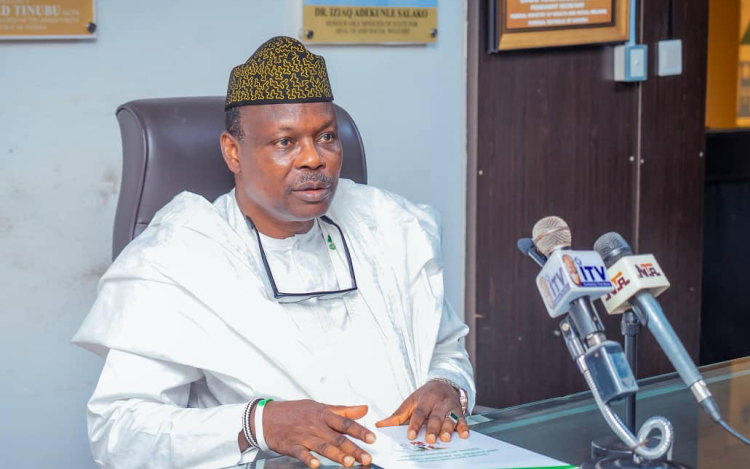 Minister Iziaq Salako briefing journalists on primary health care funding in Abuja